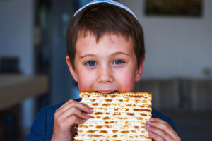 Boy eating matzah