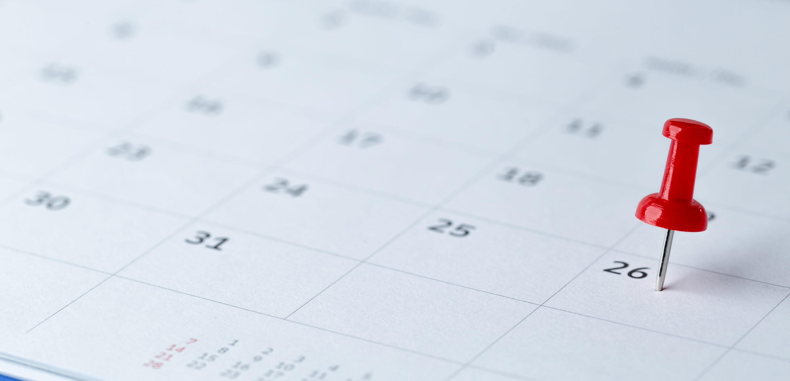 Thumbtack in calendar concept for busy, appointment and meeting