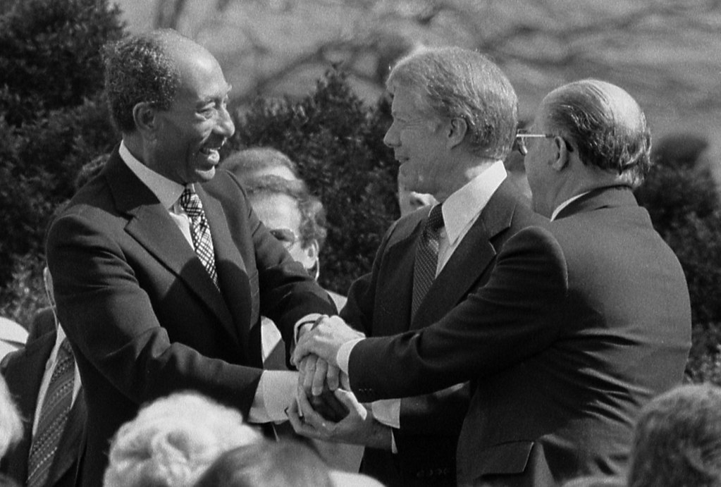 1024px-Sadat_Carter_Begin_handshake_(cropped)_-_USNWR