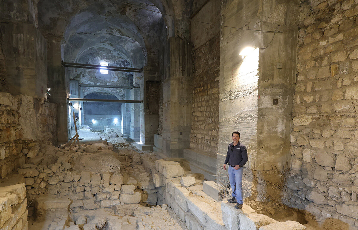 Dr. Amit Re'em stands on top of the Hasmonean Wall -credit Tower of David Jerusalem Museum
